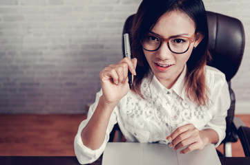 Asian woman with glasses and his pen