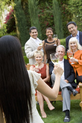 Woman announcing something to his friends while celebrating with wine
