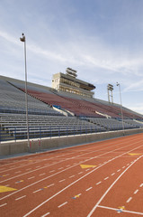 Racing tack in stadium against cloudy sky