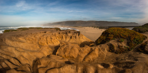 Looking at a Beach from smooth rock formation