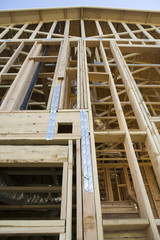 Low angle view of incomplete residential home framing under construction