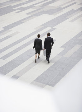 High Angle Rear View Of Businesspeople Walking In Outdoor Plaza