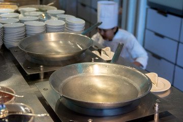 Chinese wok pan with oil in the kitchen at restaurant and Chef prepare to cook for serving in background picture