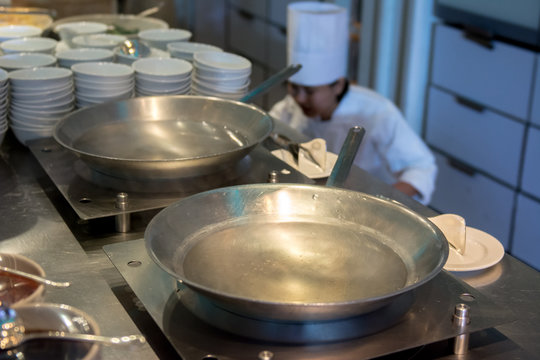 Chinese wok pan with oil in the kitchen at restaurant and Chef prepare to cook for serving in background picture