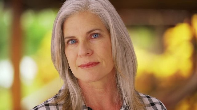 Mature mid aged woman looking serious at camera
