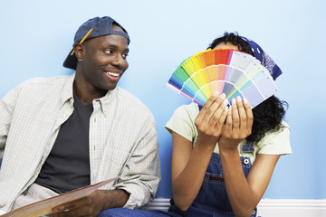 Happy African American couple with color samples to paint their new house