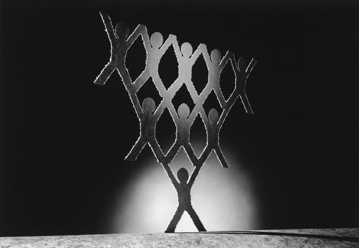 Pyramid of cut out paper figures (b&w)