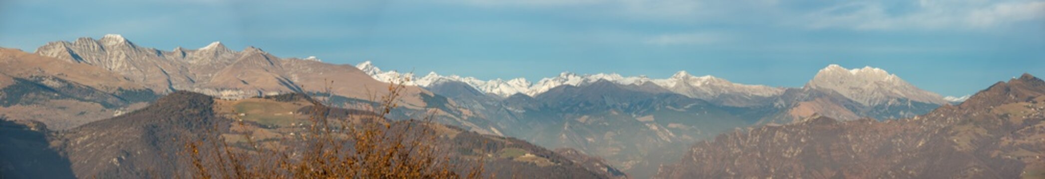 Great landscape on the Orobie Alps in fall season. View of the highest mountains including Presolana. Panorama from Rena pick, Seriana Valley, Bergamo, Italy. 