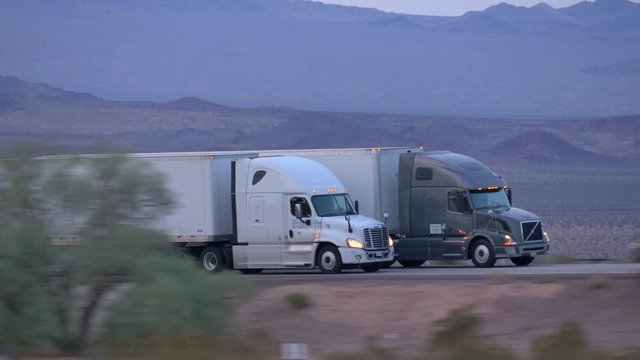 CLOSE UP: Freight semi truck driving and transporting goods on busy highway
