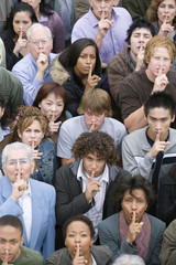 Obraz premium High angle view of people standing together with finger on lips