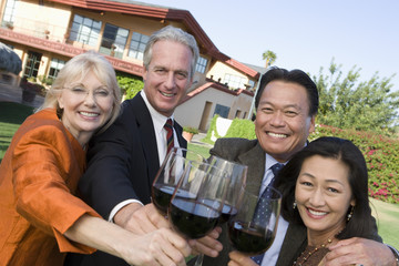 Portrait of happy multiethnic friends toasting wine glasses