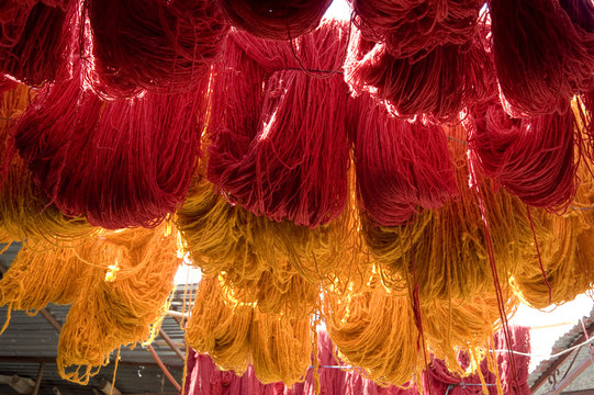 Brightly coloured wool hanging to dry in the dyers souk, Marrakech, Morocco