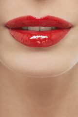 Closeup of seductive young woman with red lips