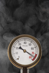 Pressure gauge at maximum omitting smoke in studio