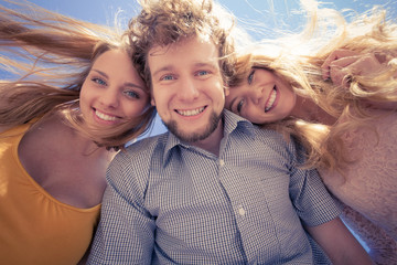 Fototapeta premium Group friends boy two girls having fun outdoor