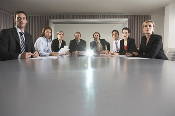 Portrait of multiethnic business people watching presentation in conference room