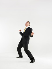 Full length portrait of a cheerful business celebrating against white background