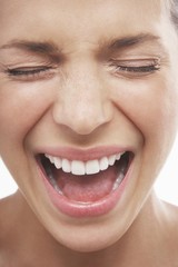 Closeup of woman screaming with eyes closed