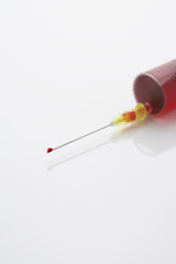 Syringe filled with blood close-up