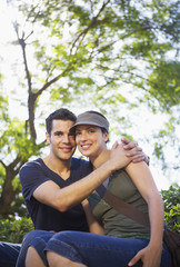 Fototapeta premium Portrait of romantic young man embracing woman at park