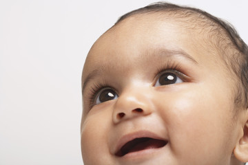Closeup of smiling baby boy isolated on white background