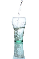 Fresh water pouring in a glass on white background