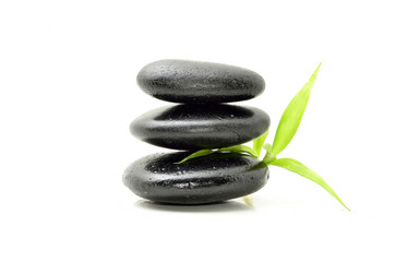 Zen stone with bamboo leaf on white background. Spa concept