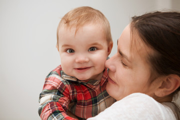 happy family. mother playing with her baby in the bedroom.


