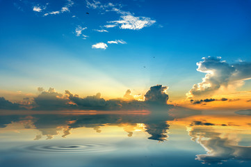 beach mirrors the sky at sunrise time