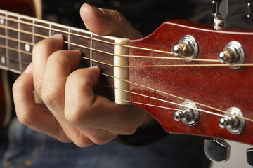 Detail shot of hands playing the guitar