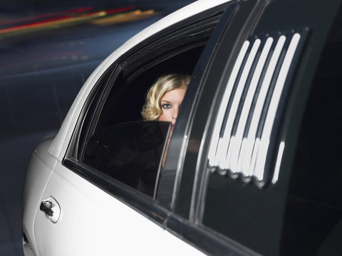 Portrait of beautiful female celebrity inside the limo car