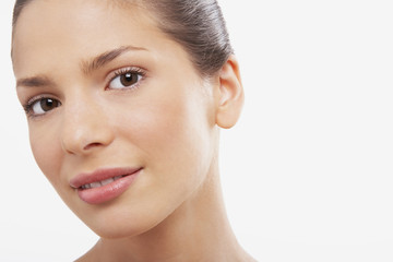 Obraz premium Closeup portrait of beautiful young woman on white background