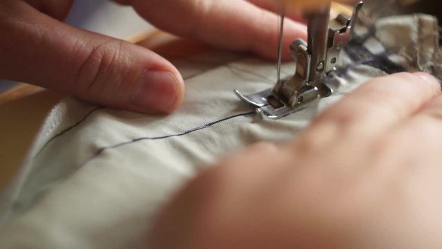 Close-up The tailor sewing on the sewing machine