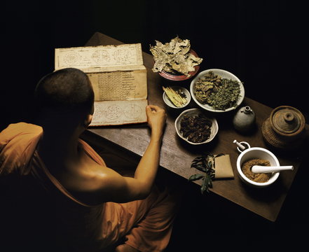 Thai monk preparing herbal medicines