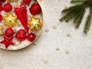Round box with red and gold Christmas decorations. New Year and Xmas card background. Copy space. Selective focus.
