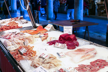 fish and sea foods on ice in market in Venice city