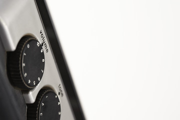 Closeup of volume and tone dials over white background