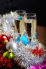 Cristmas glasses with champagne on cristmas decoration background