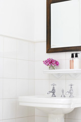 Pedestal sink and mirror frame in bathroom