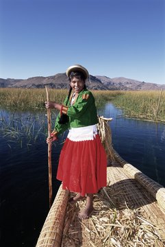 Portrait of a Uros Indian woman on a traditional reed boat, Islas Flotantes, floating islands, Lake Titicaca, Peru