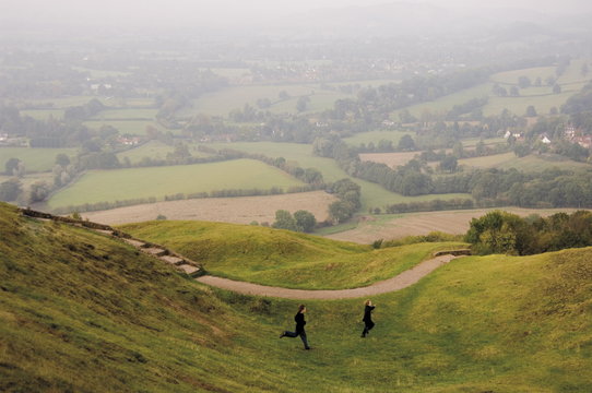 Tow children running down path, British Camp, Hereford Beacon, Malvern Hills, Herefordshire, Midlands