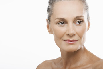 Closeup of happy middle aged woman looking away isolated on white background