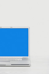 Open laptop with blue screen over white background