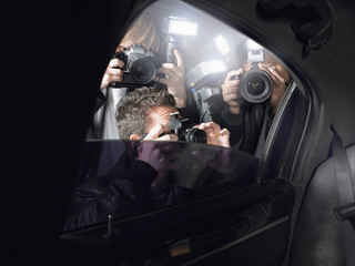 Fototapeta Paparazzi taking pictures through car window obraz