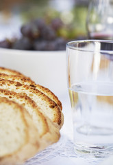 Loaf of Bread and Glass of Water on table close up