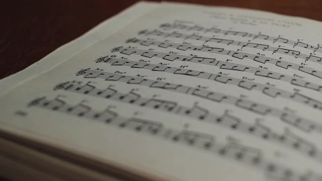 Book of musical notes of classical pieces on the table in the classroom panoramic shot