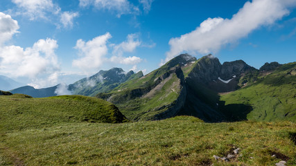 Fototapeta na wymiar Clouds rushing past a mountain peak in Switzerland