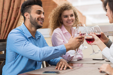 Young Business People Group Sitting At Cafe Table Toasting, Hold Wine Glasses, Friends Cheers Happy Communication Event Celebration