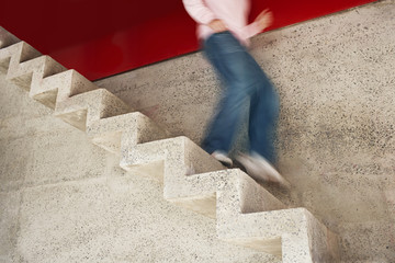 Low section of a man running down stairs