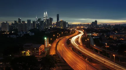 Fotobehang Light trail scenery at the busy highway in Kuala Lumpur city at night © AHMADZAIHAN